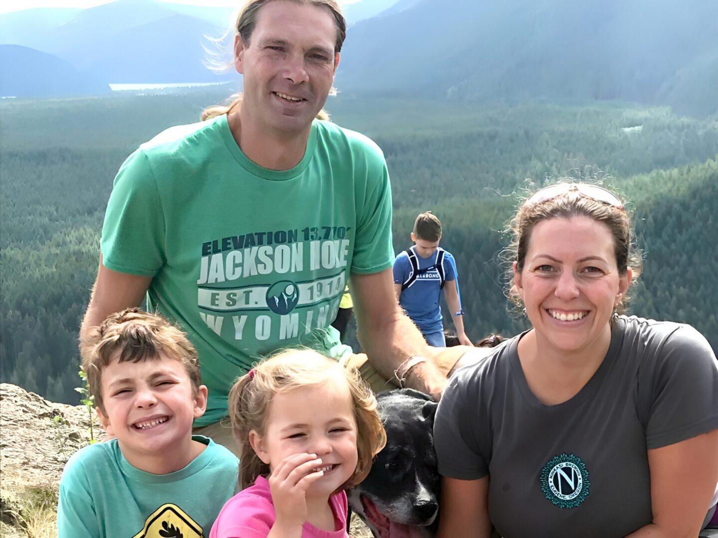 Parents and kids on scenic mountain hike