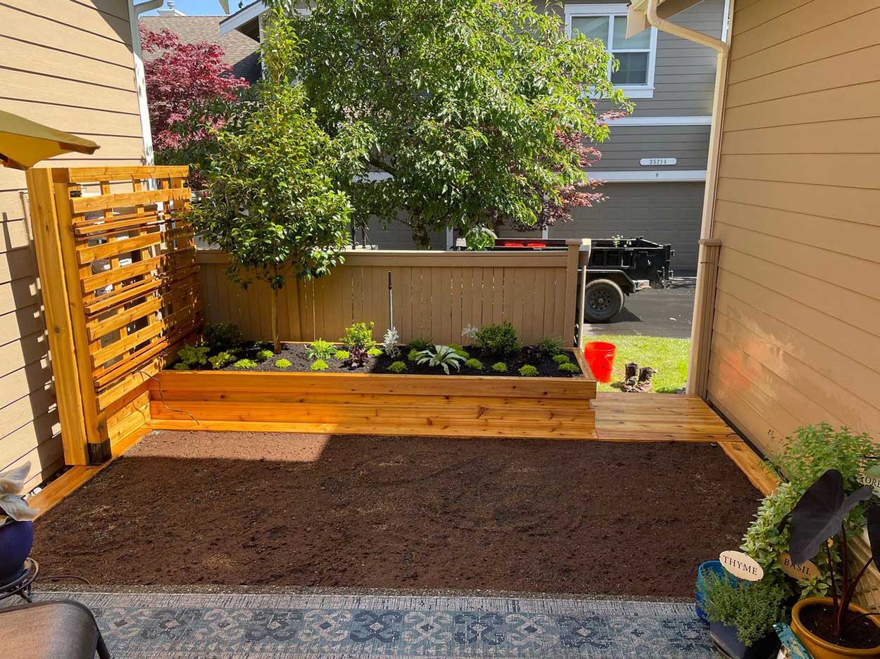 Cozy garden space with wooden planter box.